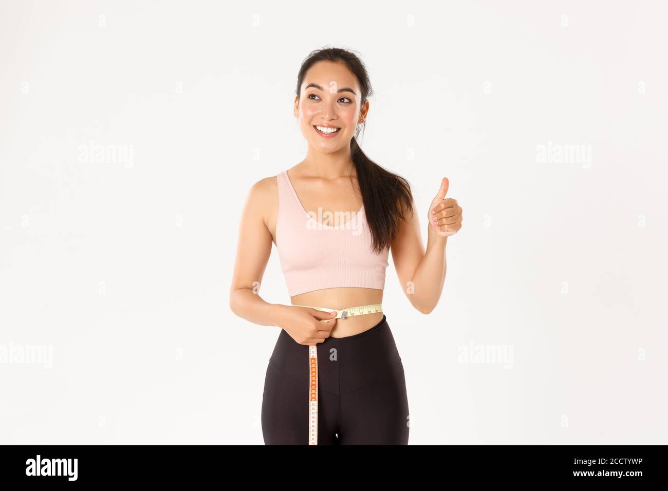 https://c8.alamy.com/comp/2CCTYWP/fitness-healthy-lifestyle-and-wellbeing-concept-portrait-of-satisfied-smiling-cute-asian-girl-in-sportswear-showing-thumbs-up-after-measuring-2CCTYWP.jpg