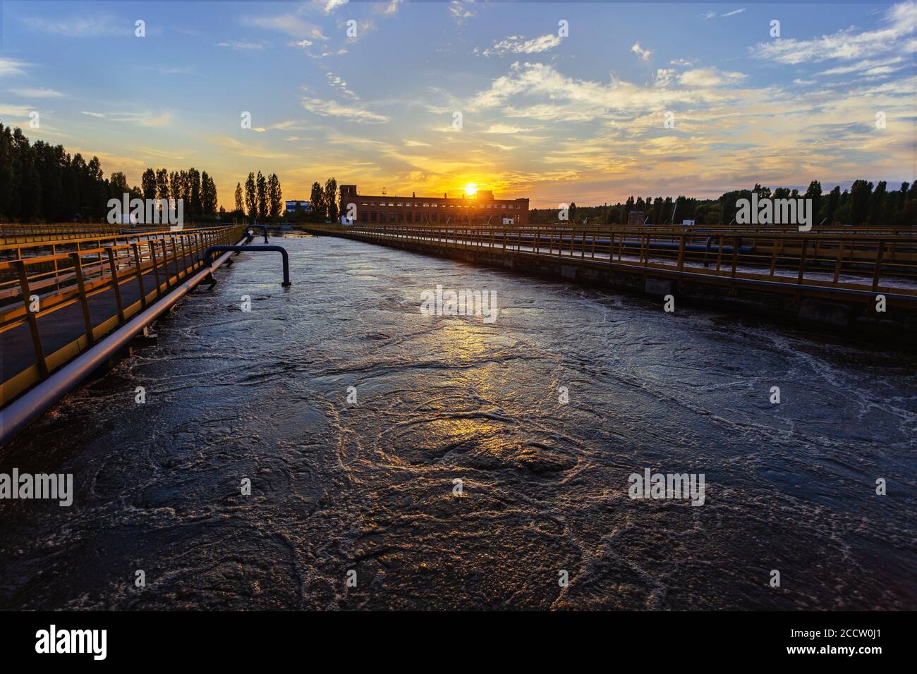 Modern wastewater treatment plant. Tanks for aeration and biological purification of sewage at sunset Stock Photo