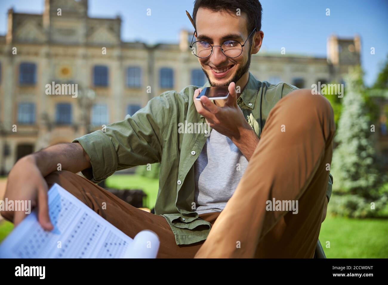 Joyful young man using his gadget outdoors Stock Photo