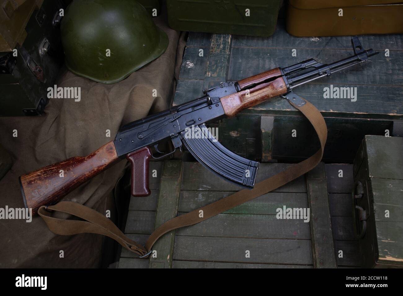 AK 47 gun with ammunitions on army green box background Stock Photo