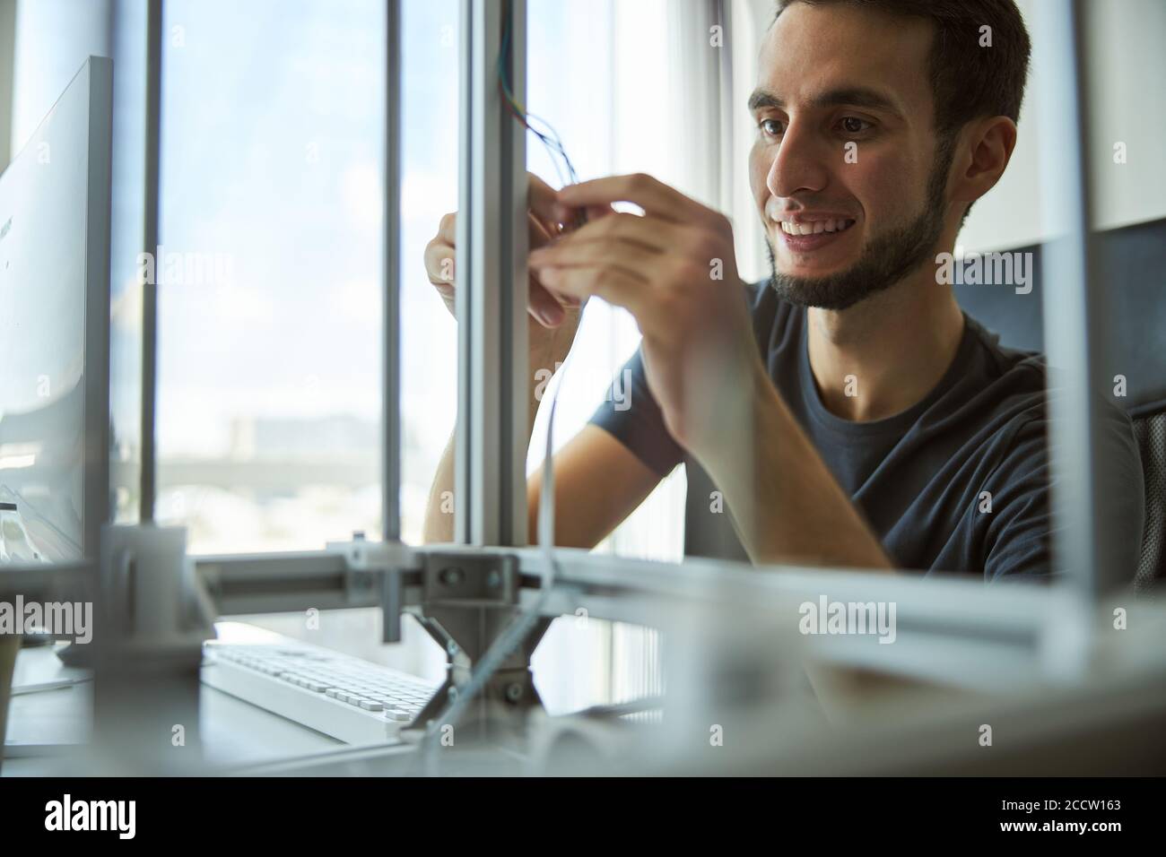 Cheerful young engineer checking the lab equipment Stock Photo