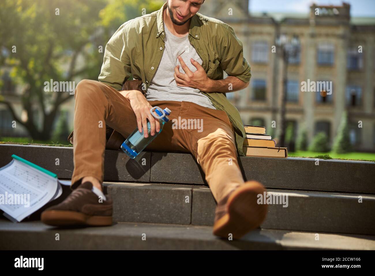 Student having a heart attack on the stairs Stock Photo