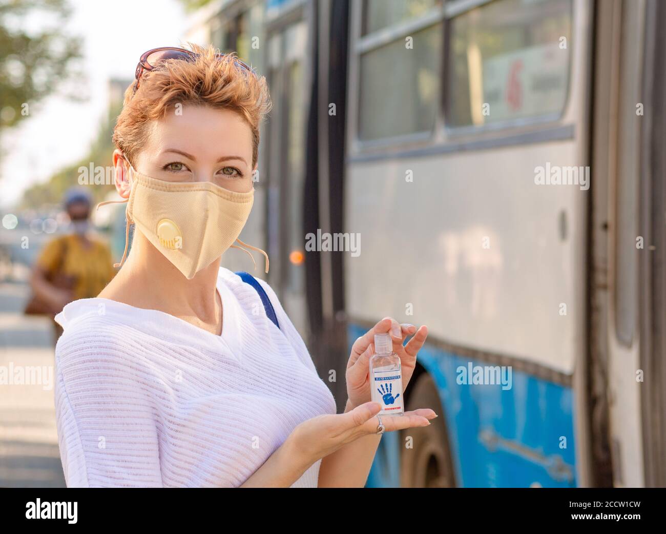 Woman showing, using antibacterial hand sanitizer with alcohol gel or ...
