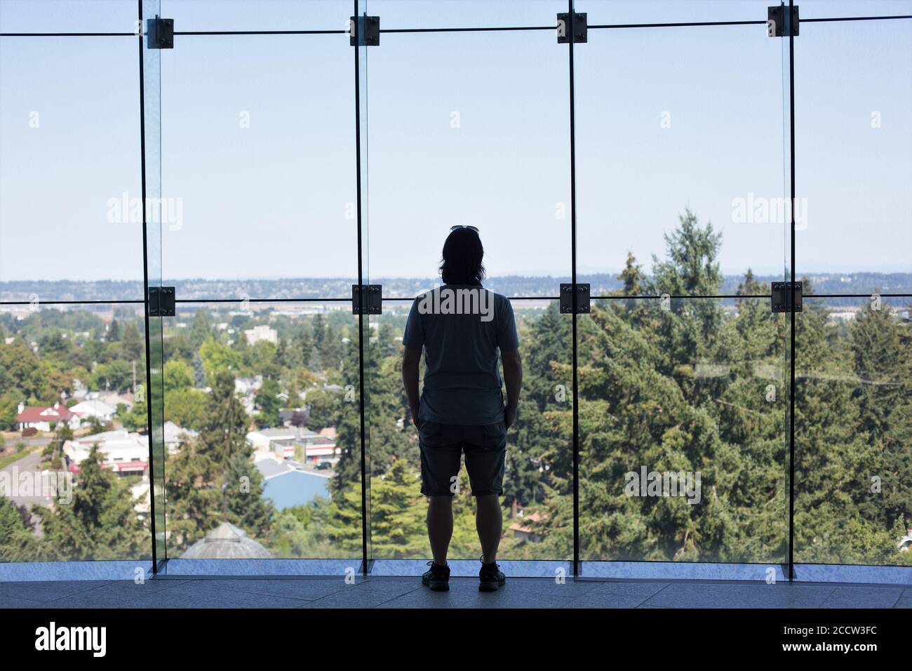 A man looking out at the view from the upper gardens at The Grotto, in Portland, Oregon, USA. Stock Photo