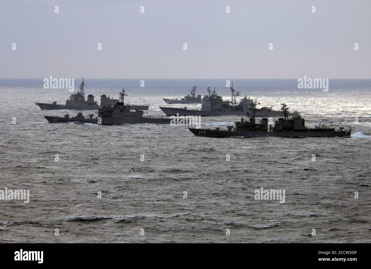 Japanese Maritime Self Defense Force (JMSDF) ships sail with an U.S. Navy ship in formation during a photo exercise in the Philippine Sea on March 18, 2007 Stock Photo