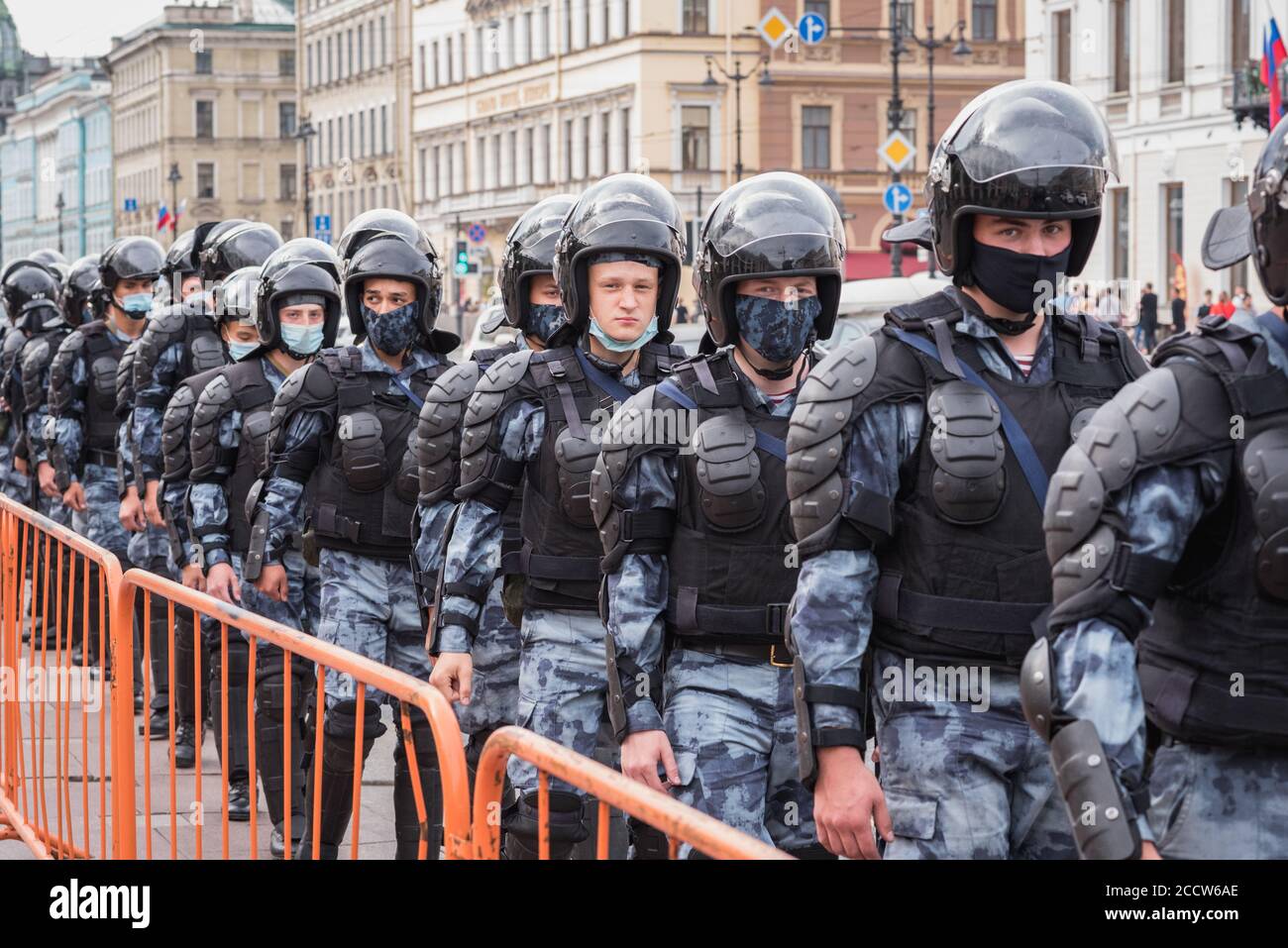 Saint Petersburg, Russia - August 22, 2020: young Russian national guardsmen in disposable masks cordon the space of a protest rally. Stock Photo
