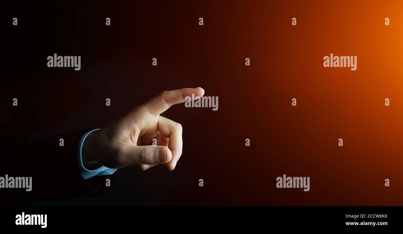 Businessman pointing finger on blurred background Stock Photo