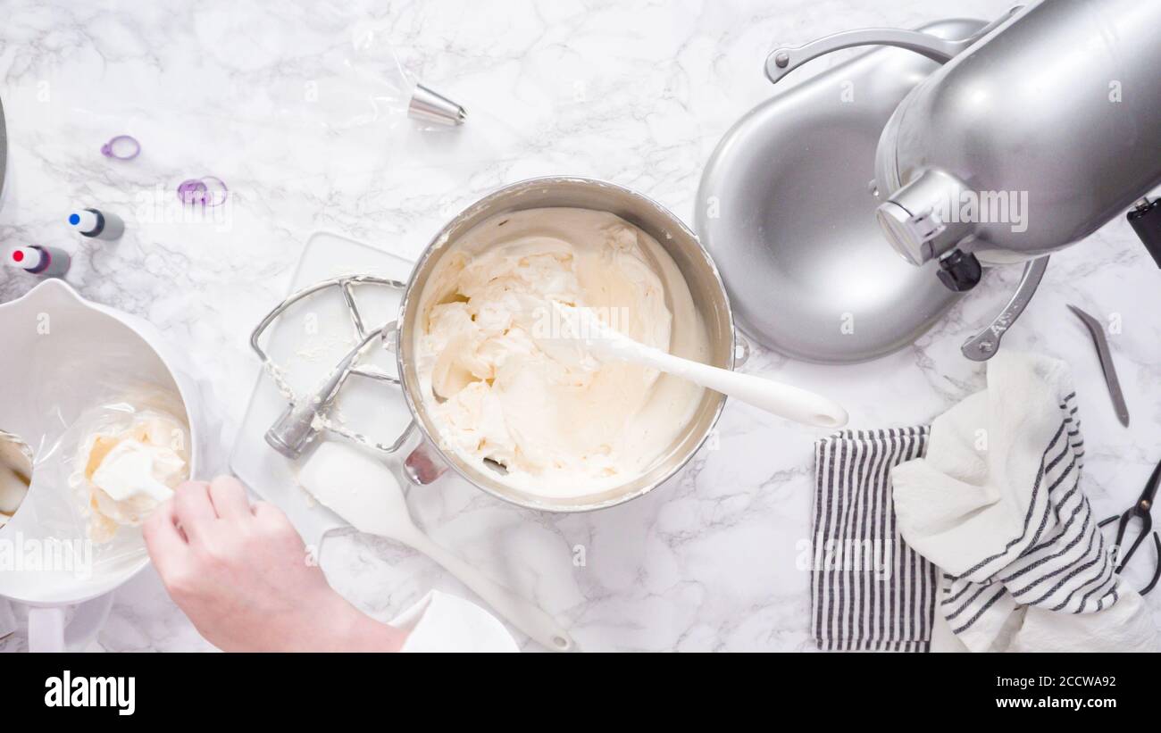 Mixing ingredients in standing kitchen mixer to make buttercream