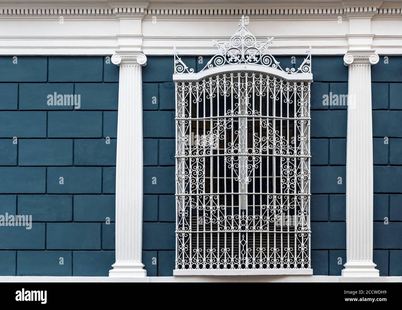 Colonial style facade with columns and wrought iron ornate window, Trujillo, Peru. Stock Photo