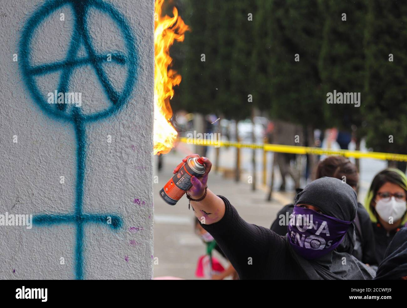 A woman sets a fire outside Attorney General's Office, during a protest in  Mexico City, Mexico,