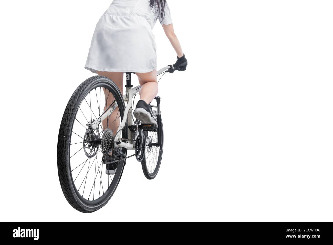 Rear view of a woman riding a bicycle isolated over white background ...