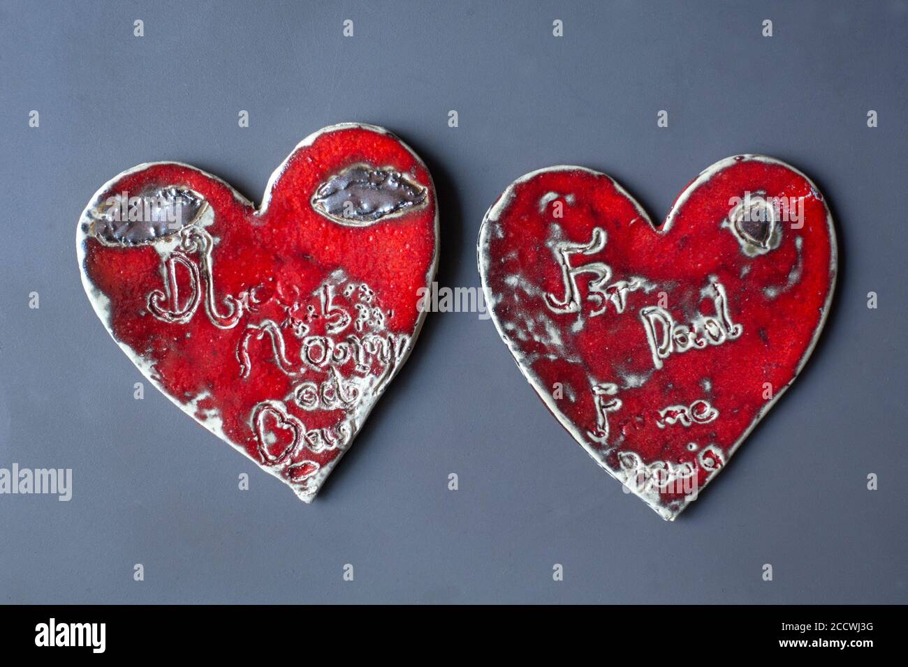 Artistic red pottery hearts made by a young Polish girl as a gift for her parents. Warsaw Poland Stock Photo