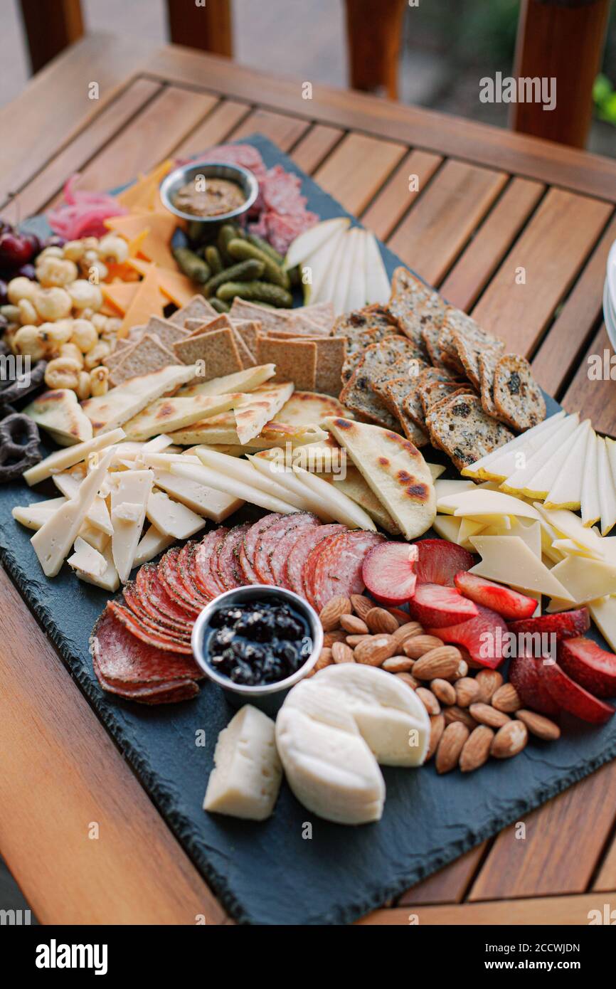 Charcuterie Board with fruit, vegetables, crackers, cheese, and dips