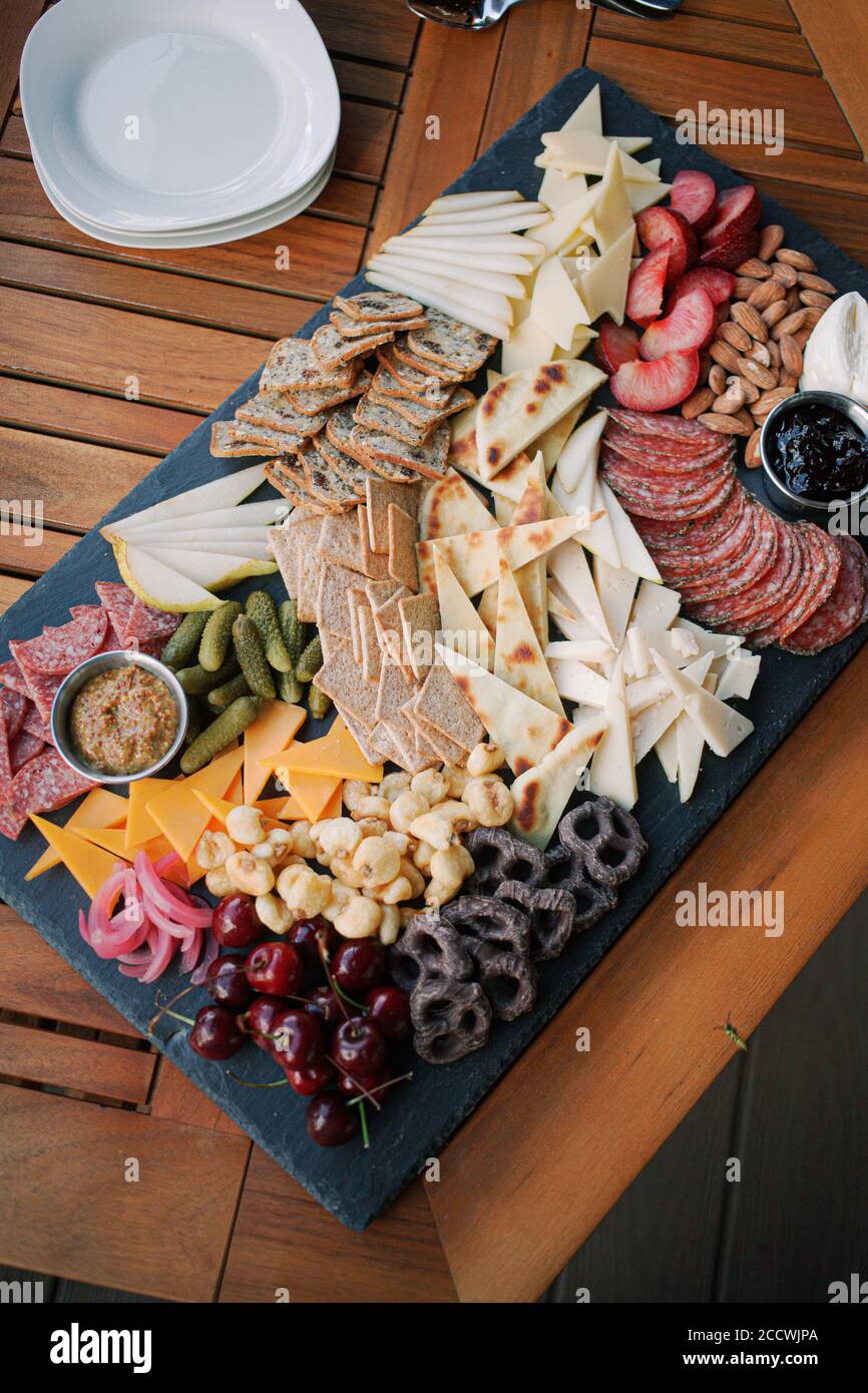 Charcuterie Board with fruit, vegetables, crackers, cheese, and dips