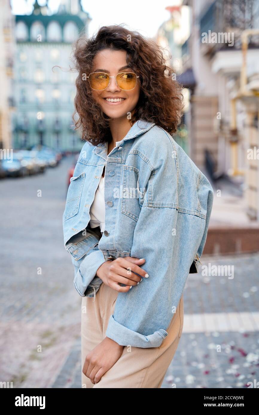 Stylish teen model posing on town streets after quarantine. Stock Photo