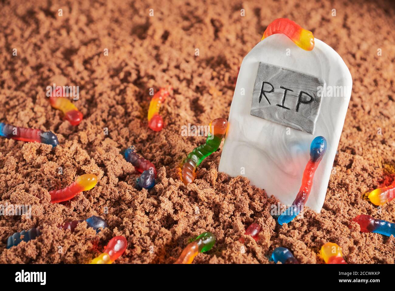 Colorful And Bright Assorted Gummy Worms In Chocolate Cake Ground Around A Sugar Gravestone Halloween Party Fun Food Stock Photo Alamy