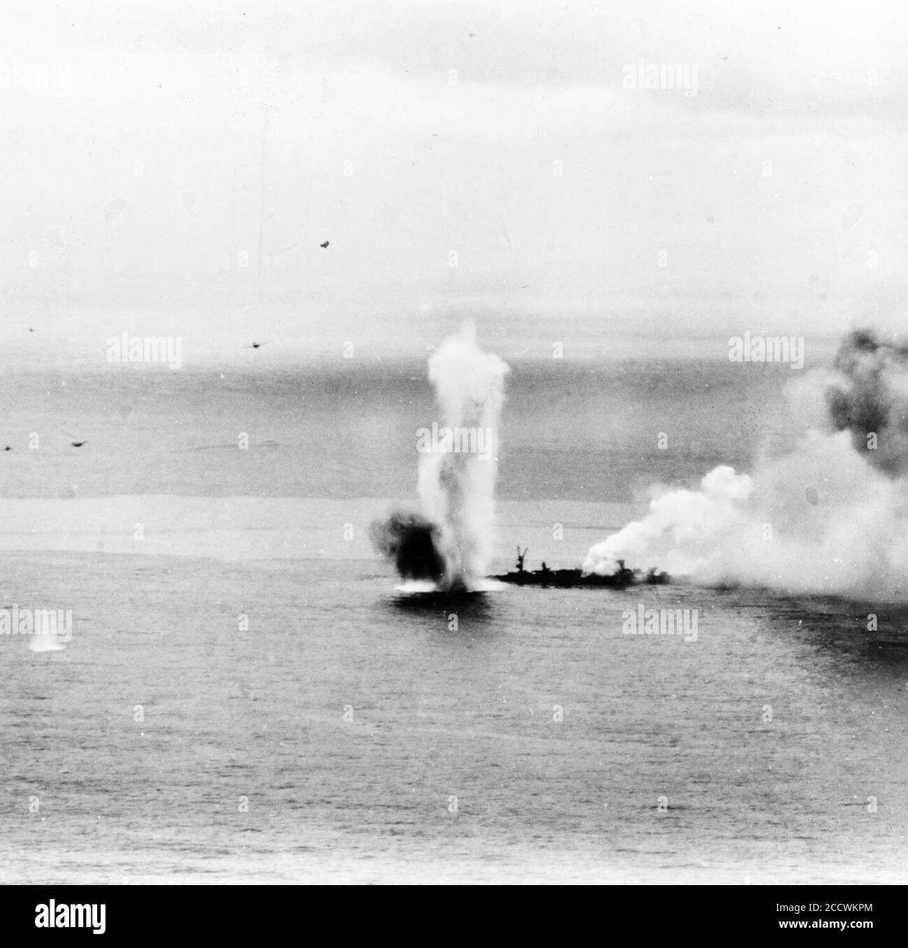 Japanese light cruiser Yahagi under attack and listing heavily, 7 April 1945 (NH 62575). Stock Photo