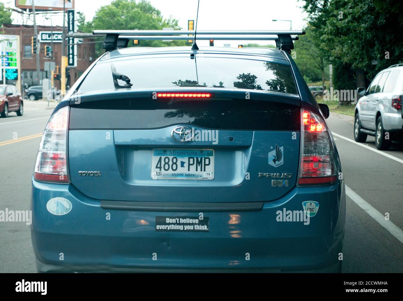 Car with a bumper sign saying "Don't believe everything you think". St