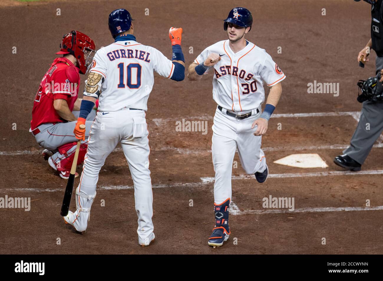 Houston, United States. 24th Aug, 2020. Houston Astros' Kyle Tucker and Yuli Gurriel celebrate a solo home run by Tucker against the Los Angeles Angels in the second inning at Minute Maid Park in Houston on Monday, August 24, 2020. Photo by Trask Smith/UPI Credit: UPI/Alamy Live News Stock Photo