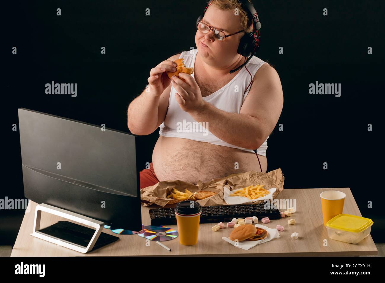 obese guy has ruined the diet with yummy hamburger. Gluttony concept. man cannot control his appetite. enjoyment.man gets pleasure from eating favouri Stock Photo