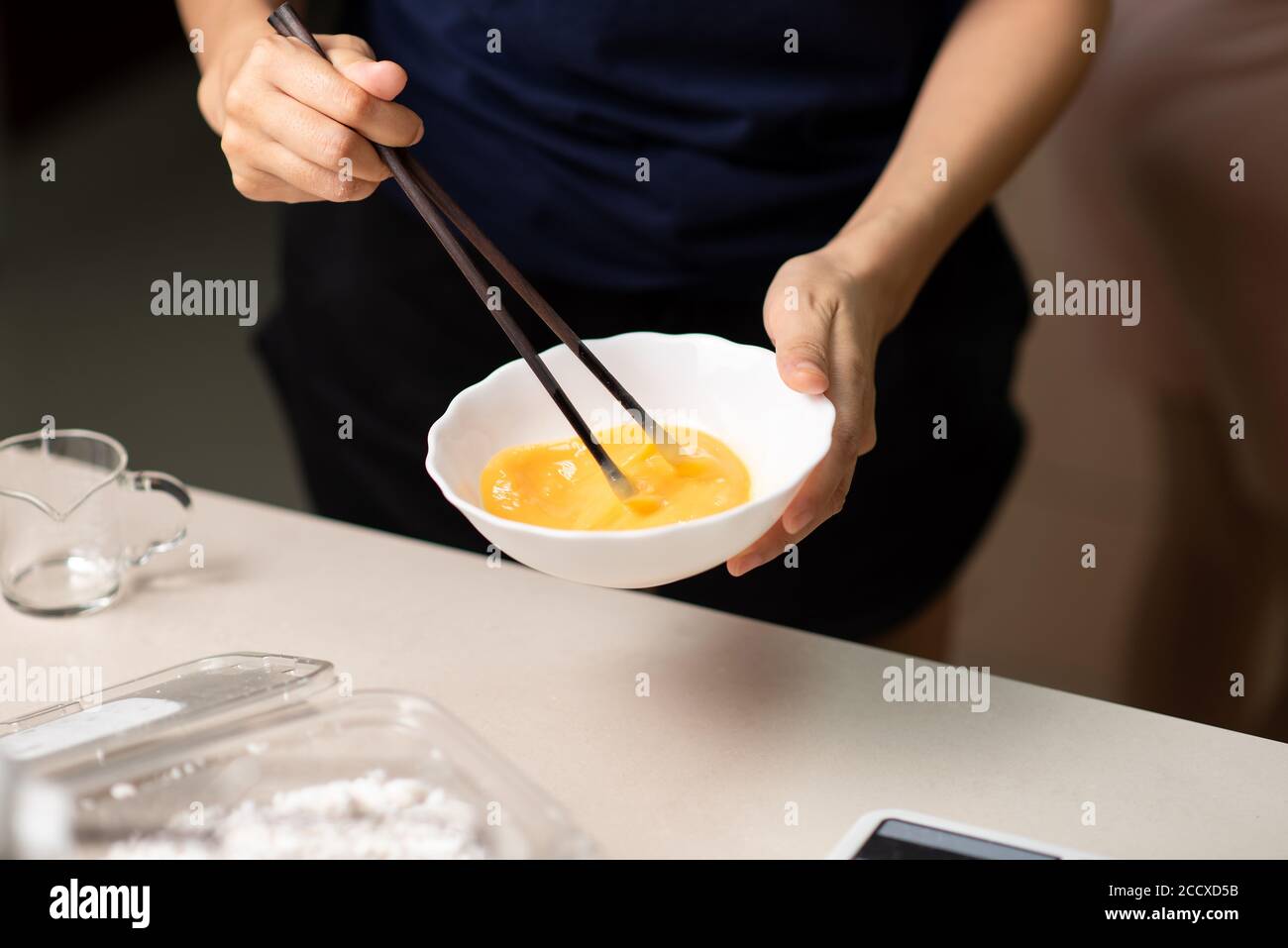 Food That Involves Beating Woman beating eggs with chopsticks closeup, Asian food preparation and ...