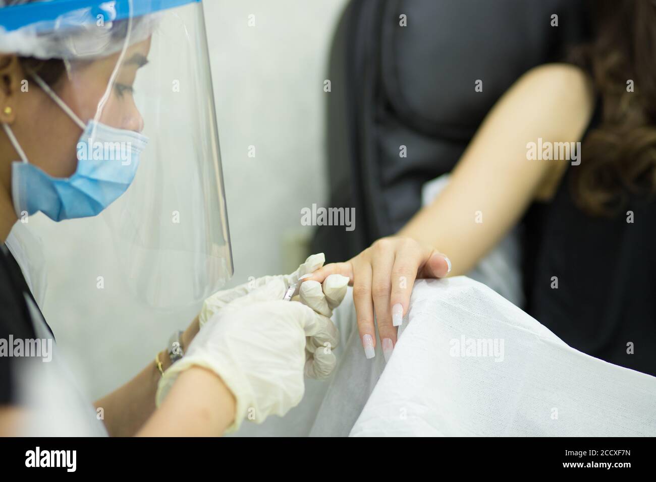 female getting hand treatment in saloon, spa Stock Photo
