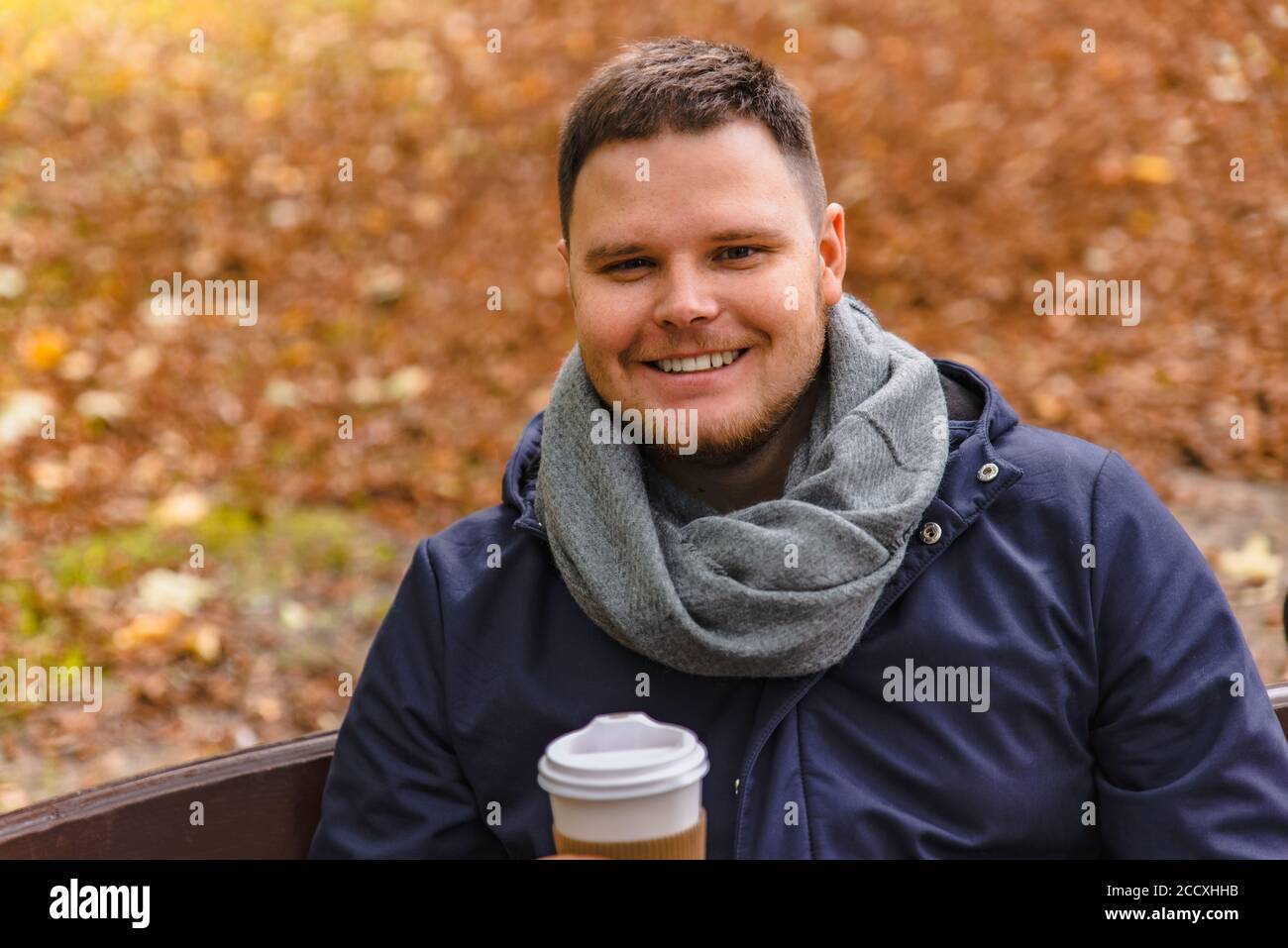 man drinking coffee outdoors autumn season Stock Photo
