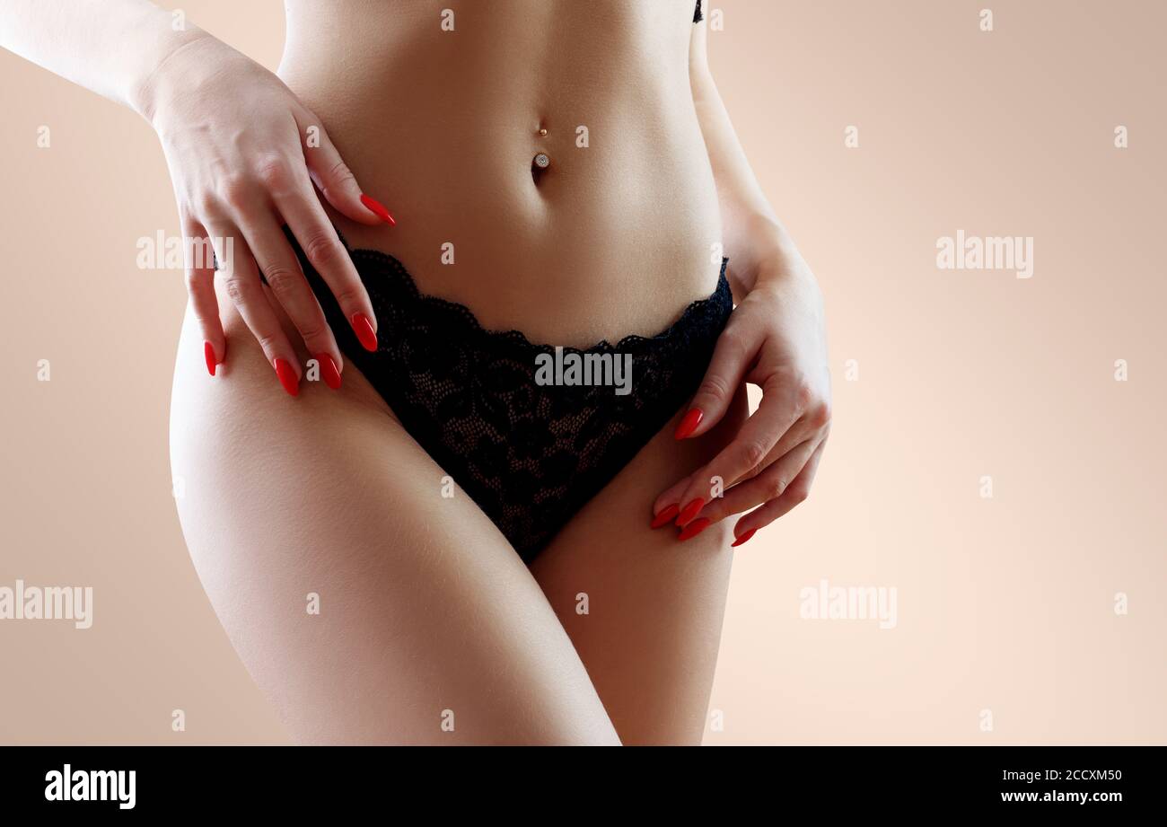 Beautiful woman in black lace panties with perfect belly. Stock Photo