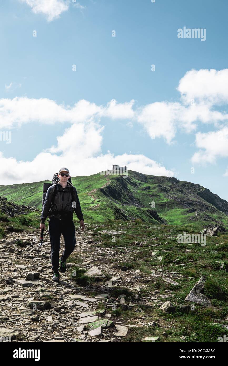 young hiker man in mountains. summer trekking path Stock Photo - Alamy