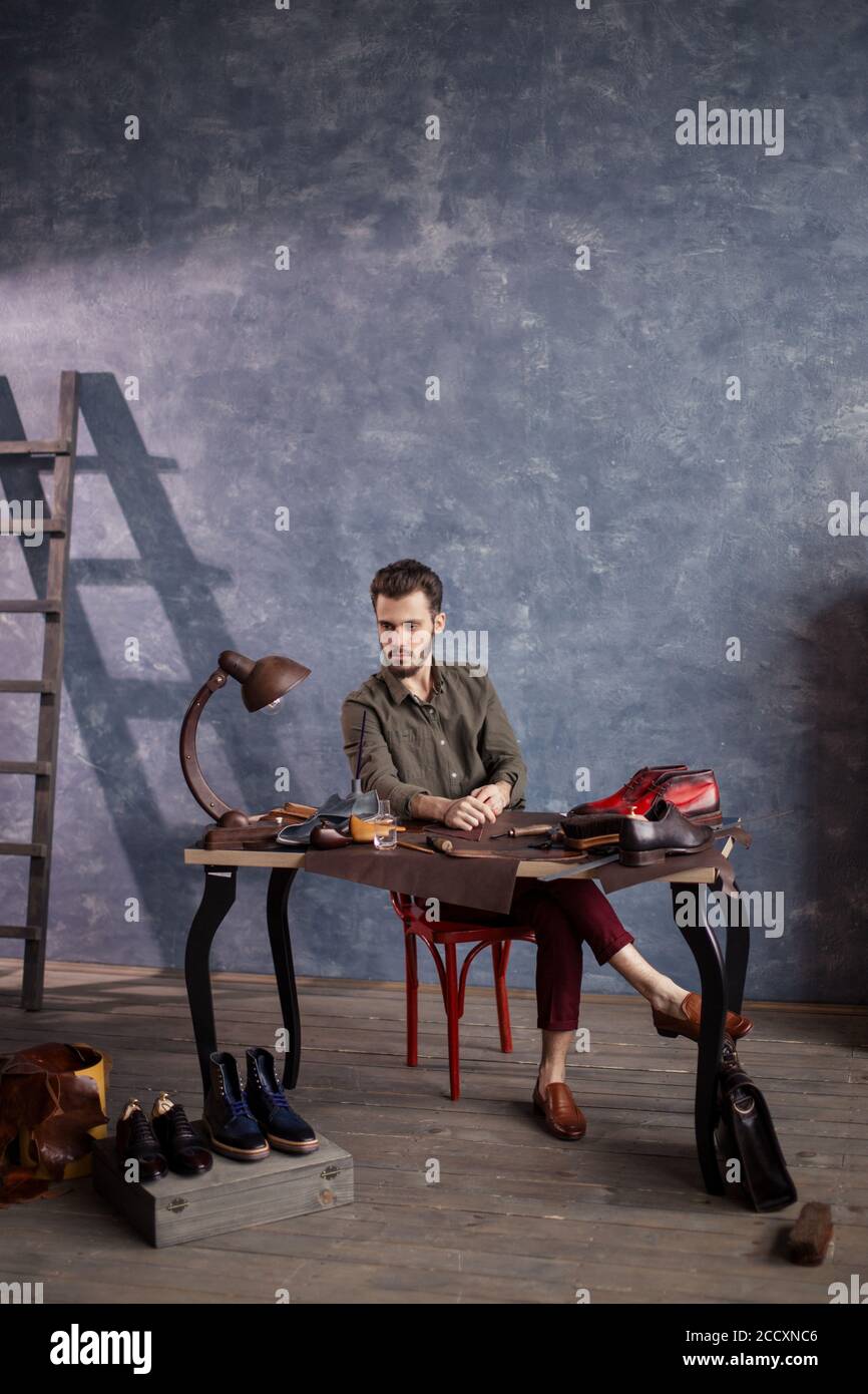 boss craftsman controlling the work of shoemakers, full length photo Stock Photo