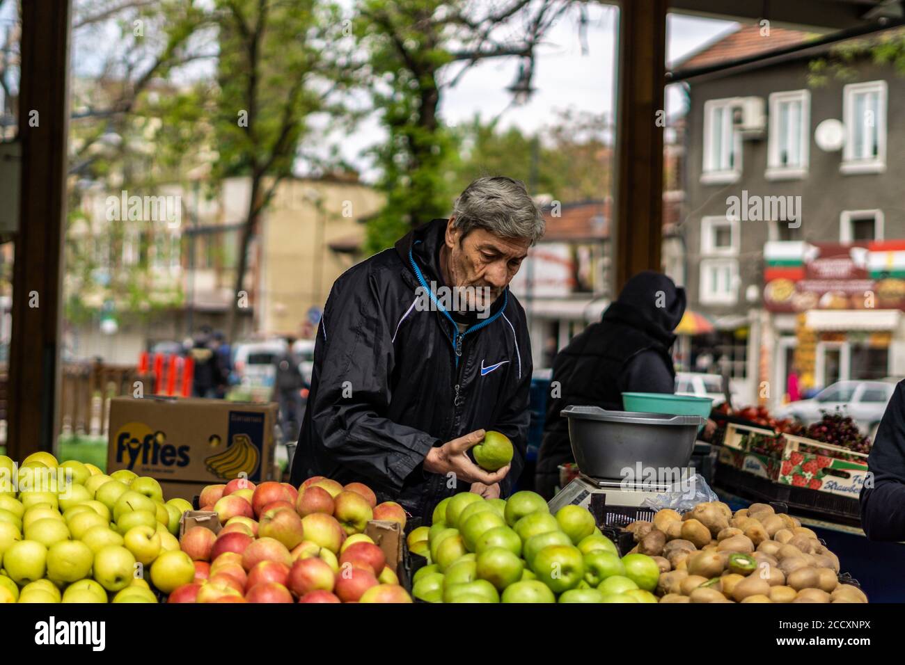 Men selling fruits at the central market of Sofia, Bulgaria Stock Photo