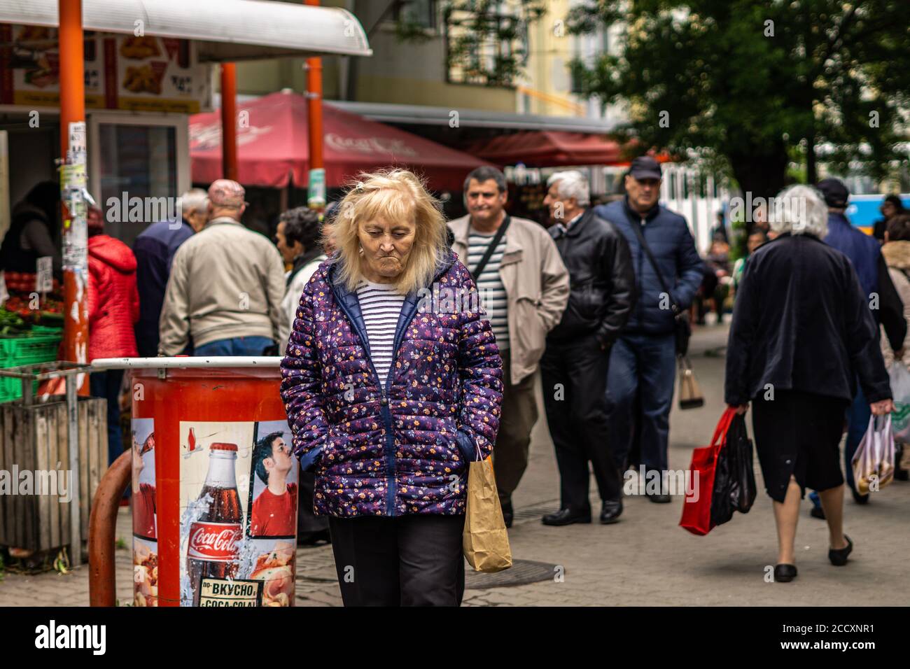 Elderly woman walking in central market of Sofia, Bulgaria Stock Photo