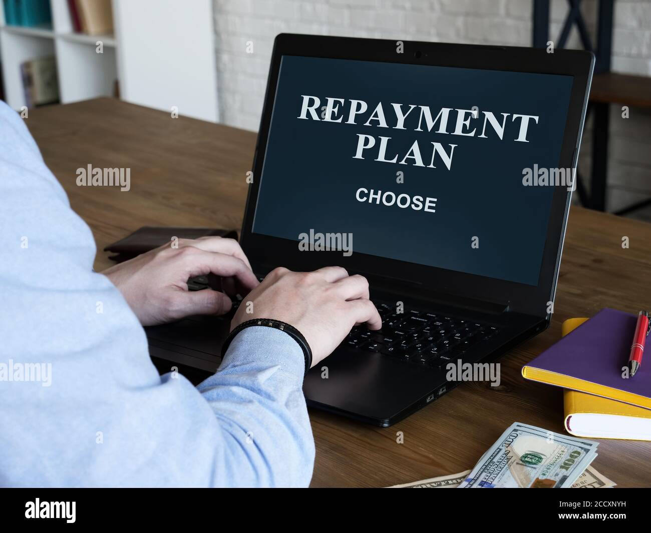 The man reads about loan repayment plan and chooses. Stock Photo