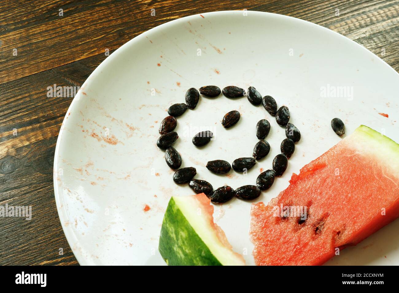 A slice of watermelon and a smile on plate. Healthy food in summer. Stock Photo