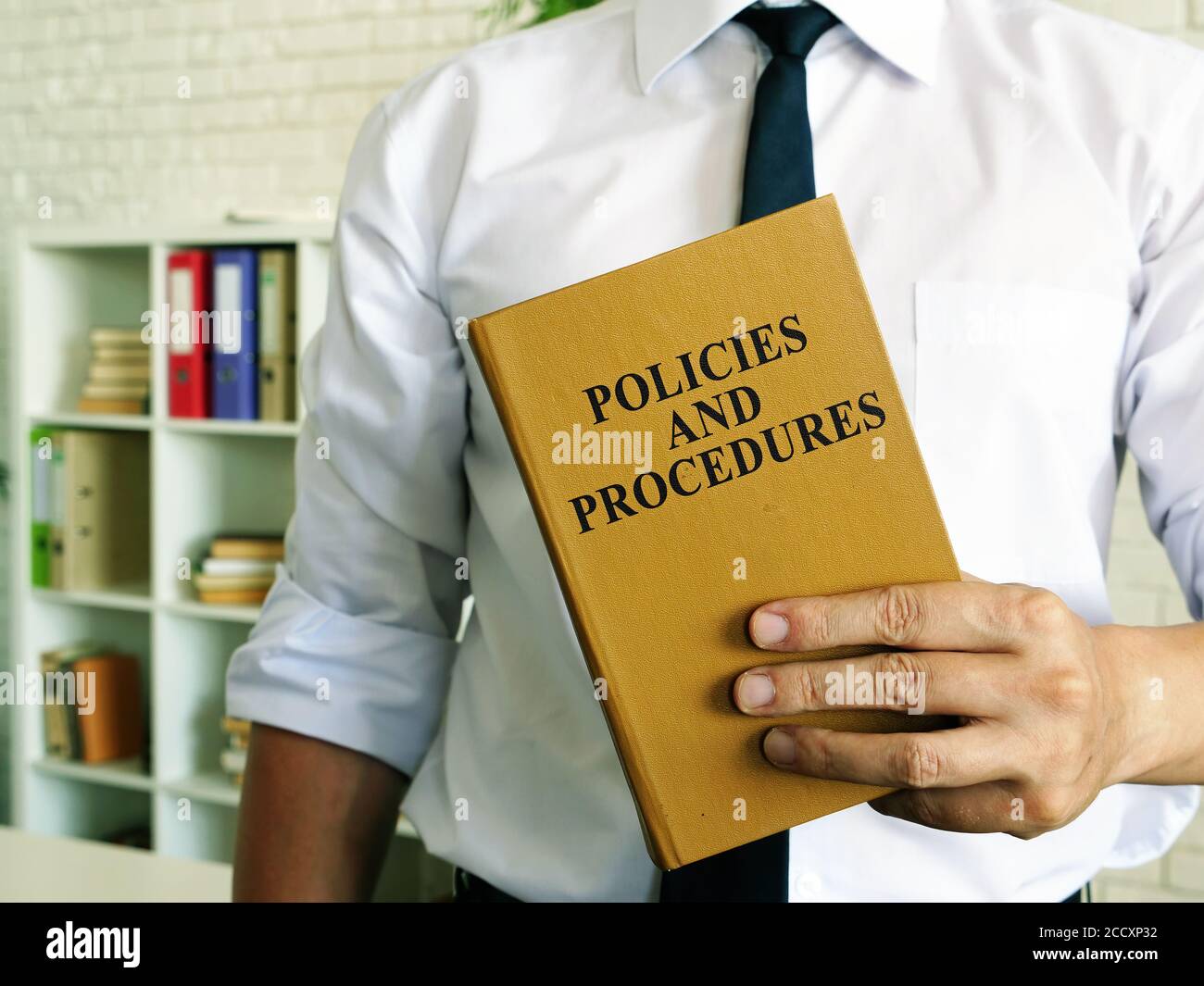 The manager offers Policies and procedures book. Stock Photo