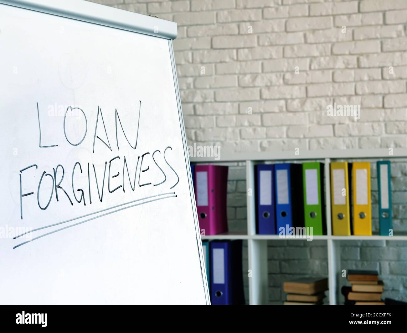 Loan forgiveness inscription on the white board in office. Stock Photo