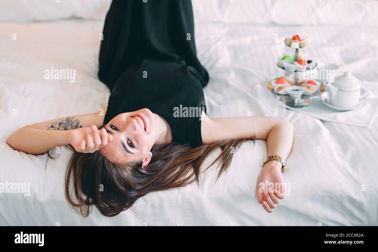 Premium Photo | Beautiful morning of the bride in a light boudoir dress in  a hotel on the bed. a young girl poses and smiles before the wedding.