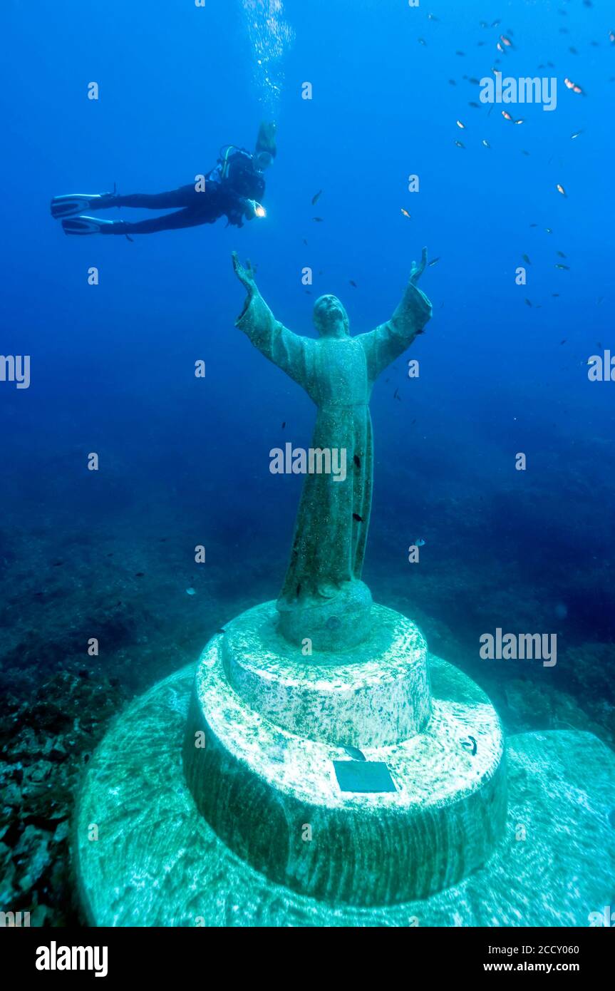 Diver at Christ statue under water, Mediterranean Sea, bay of San Fruttuoso, Portofino, Liguria, Italy Stock Photo