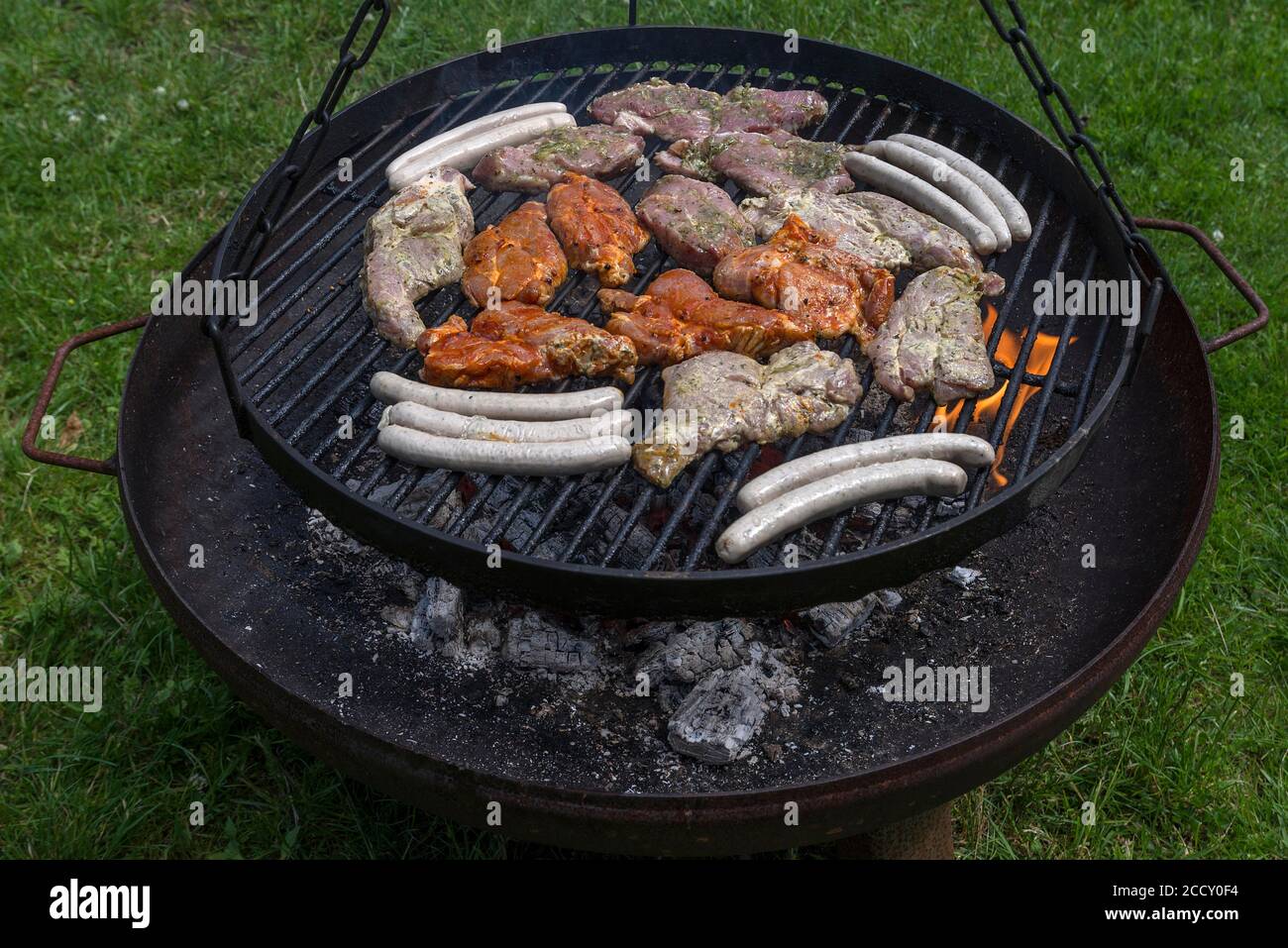 Barbecue food on a swivel grill, Mecklenburg-Western Pomerania, Germany Stock Photo