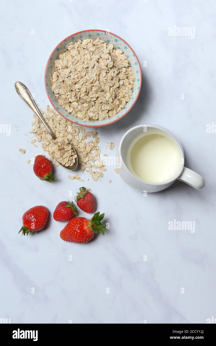 Oat flakes in shell, milk and strawberries, Germany Stock Photo