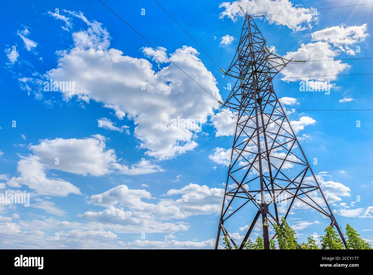 High electricity tower and blue cloudy sky Stock Photo - Alamy