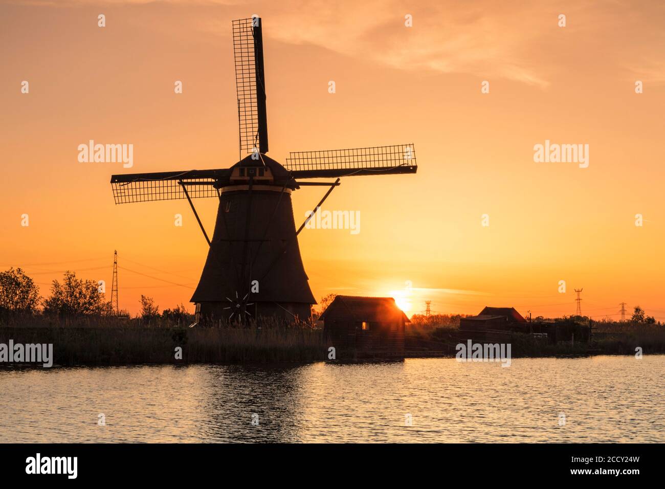 Windmill at sunrise, Kinderdijk, UNESCO World Heritage, Zuid-Holland, Netherlands Stock Photo