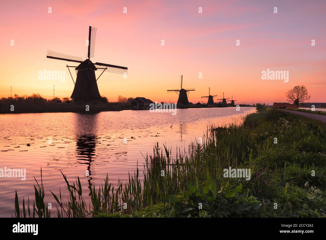 Windmills at sunrise, Kinderdijk, UNESCO World Heritage, Zuid-Holland, Netherlands Stock Photo