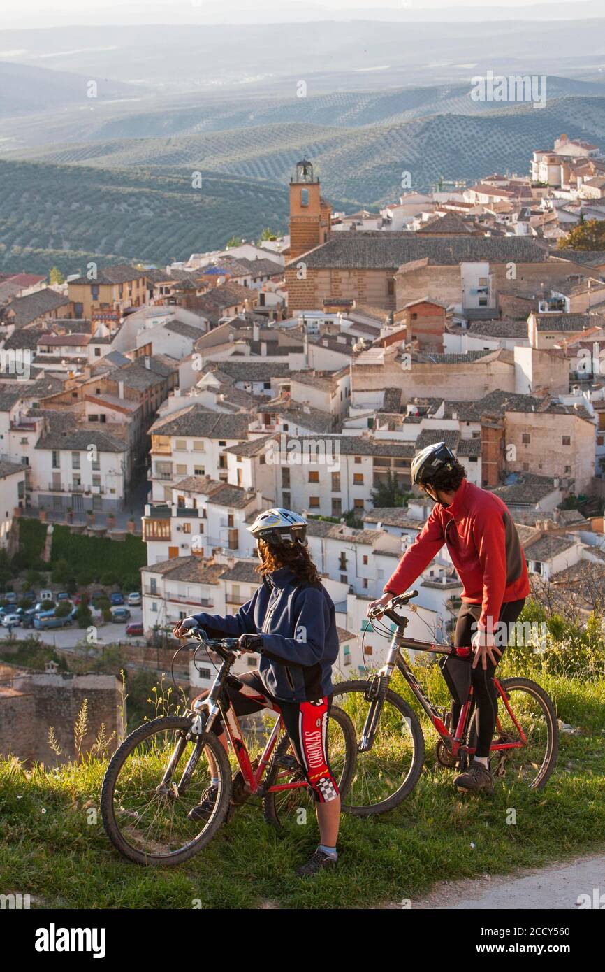 Two mountain bikers observe the village of Cazorla, province of Jaen, Spain Stock Photo