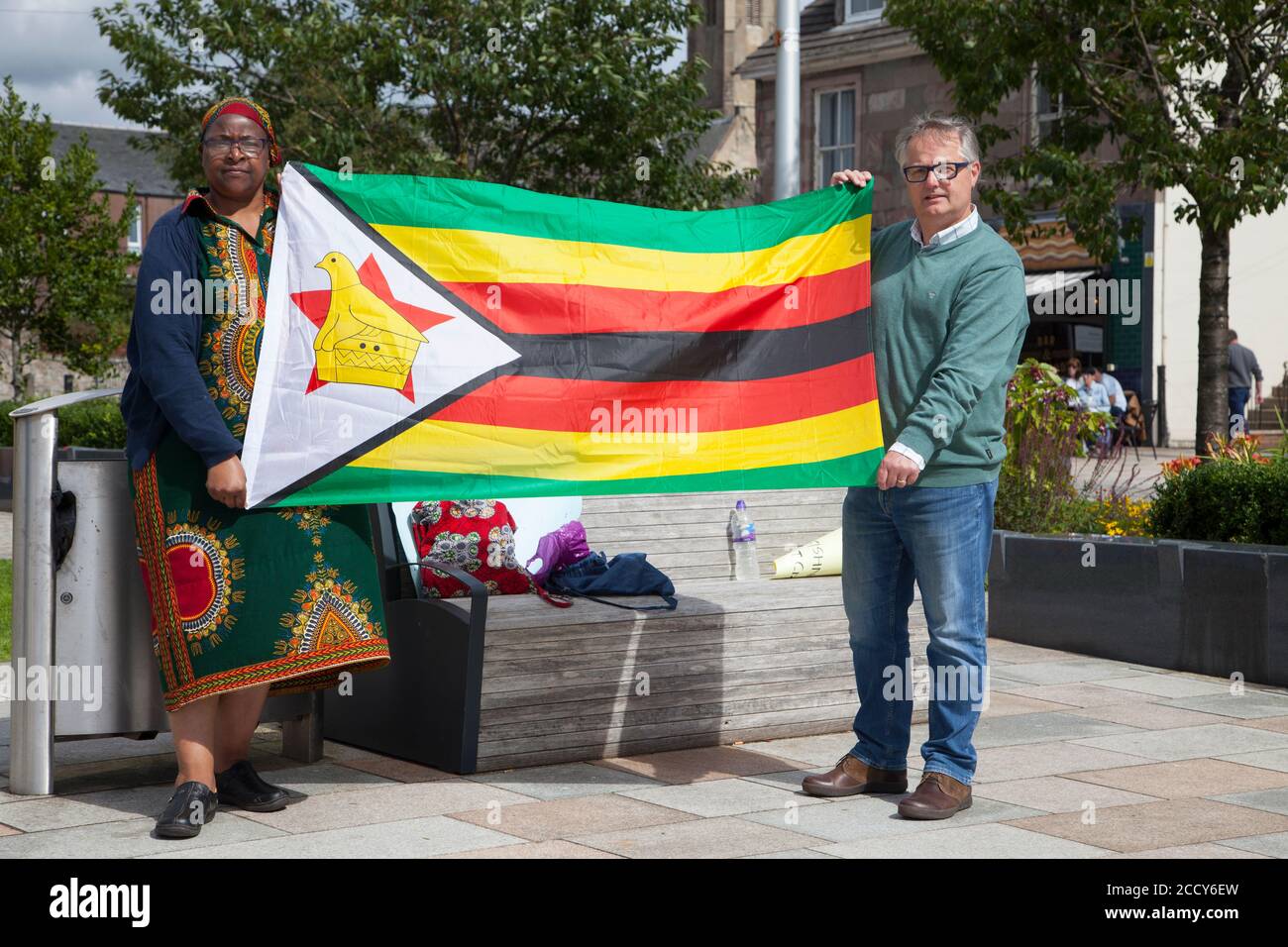 Protesters at the Zimbabwe lives matter protest at Helensburgh, with placards and flag, in support of Harriet Ndlovu, including  MP Brendan O'Hara. Stock Photo