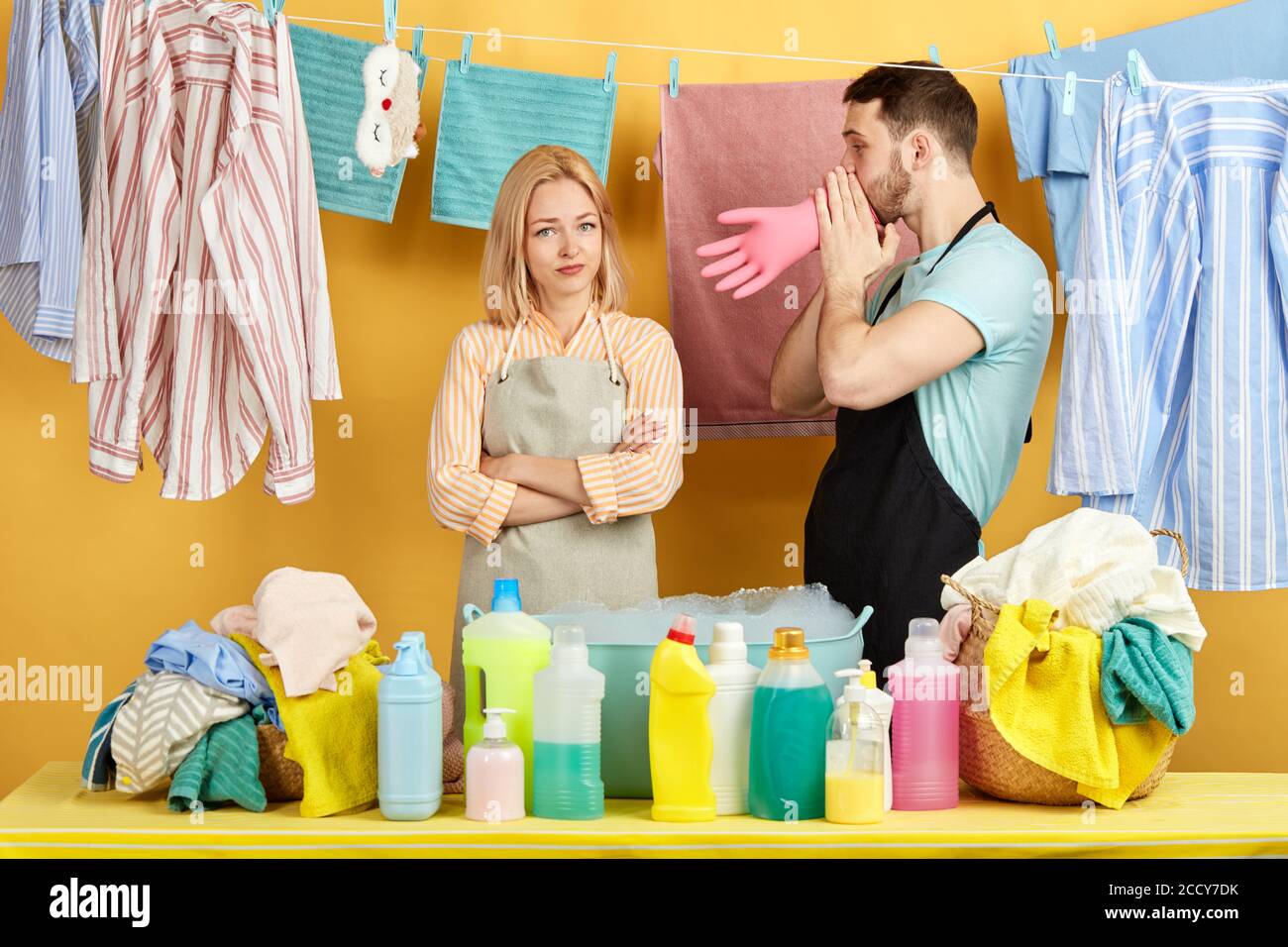good looking funny guy teasing his girl while doing laundry. close up