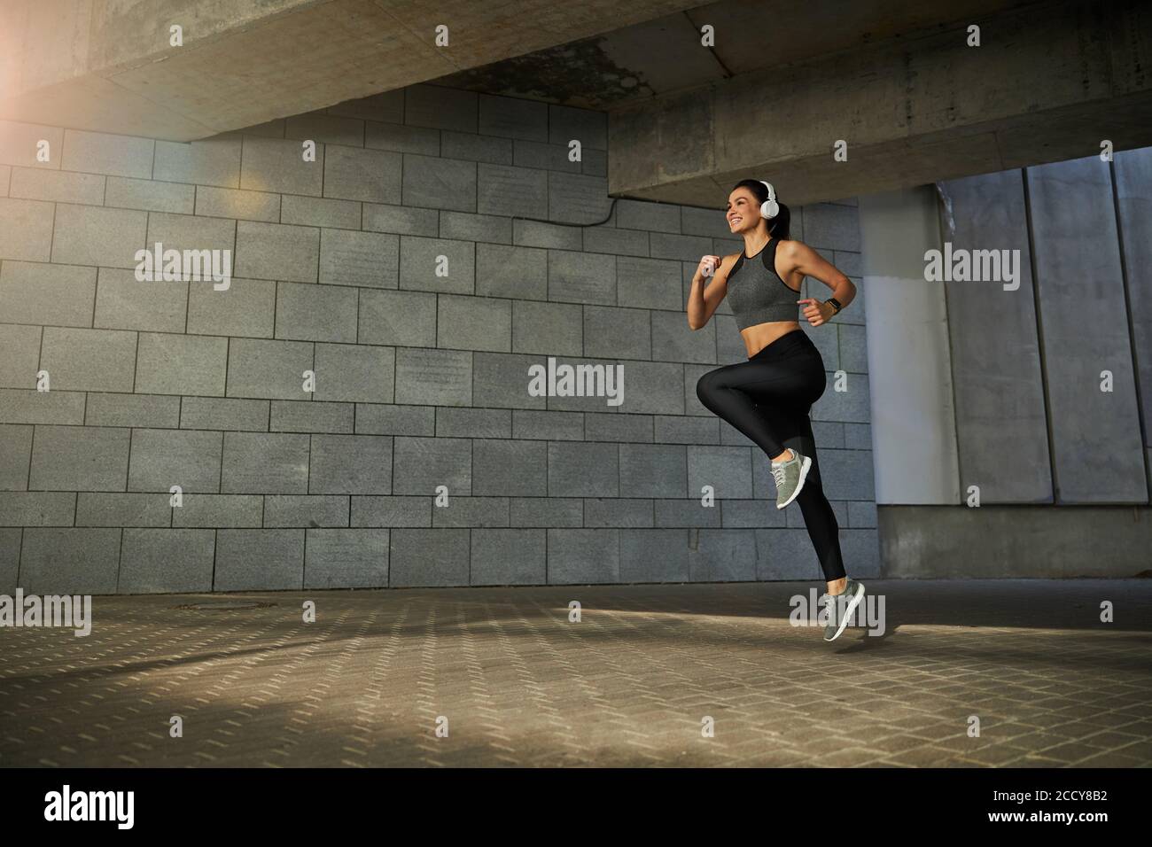 Positive delighted young female person jumping high Stock Photo