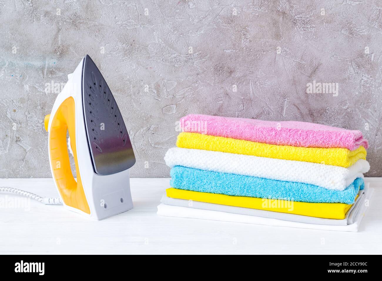 Close up of iron and towels on ironing board Stock Photo