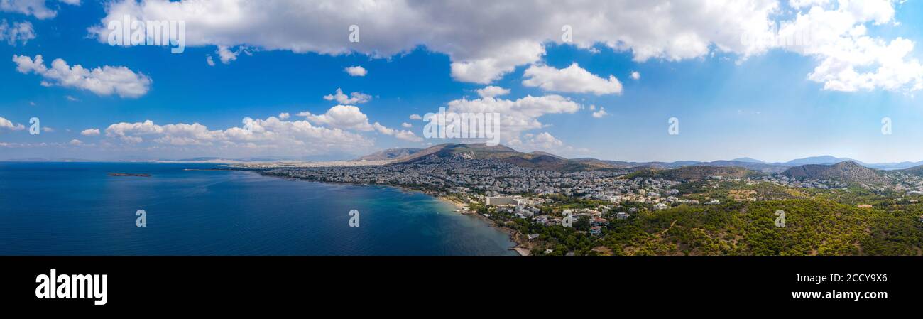 Athens Greece riviera panorama. Aerial drone view of Voula and Glyfada coastline, high class residential distric. Cloudy blue sky over sea water, sunn Stock Photo