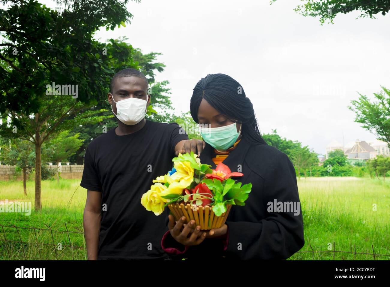Shot couple masks holding hi-res stock photography and images - Alamy